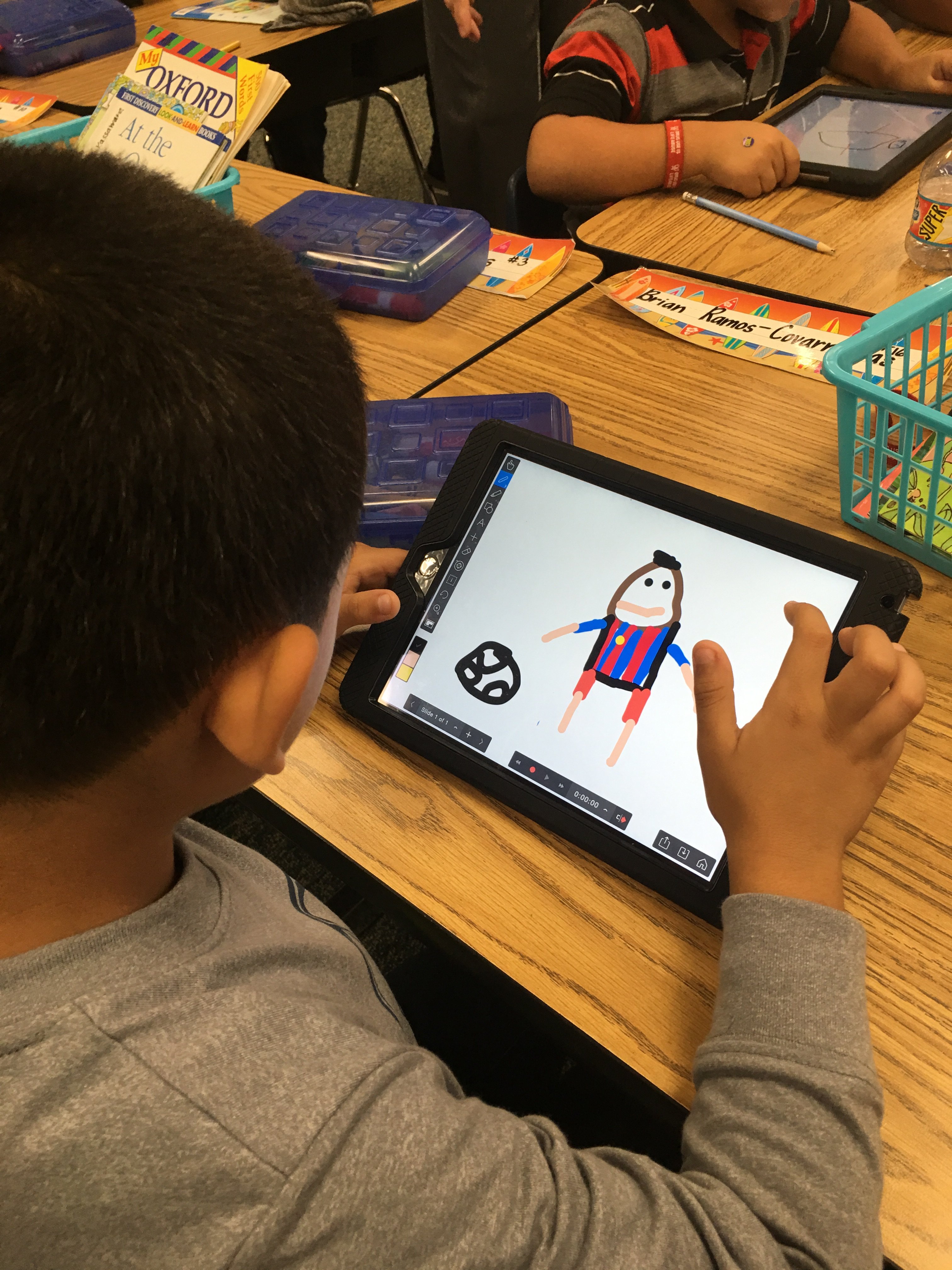 Students use tablets to draw, practice skills, learn reading and writing, and more!