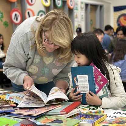 Mrs. Redmond reading books with students!